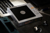 Cayin CP6 portable tube CD player, on a desk beside a laptop