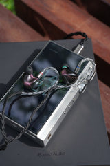 iBasso DX340 MAX music player, with earphones, angled