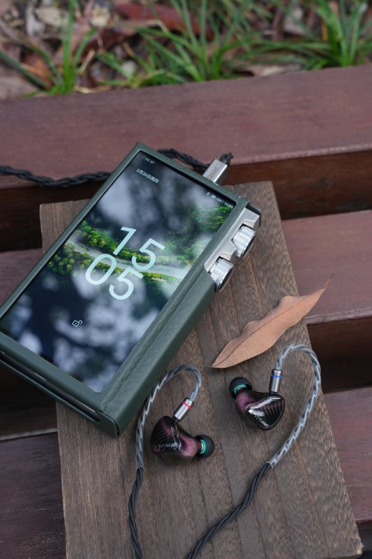 iBasso DX340 MAX music player, on a bench with earphones