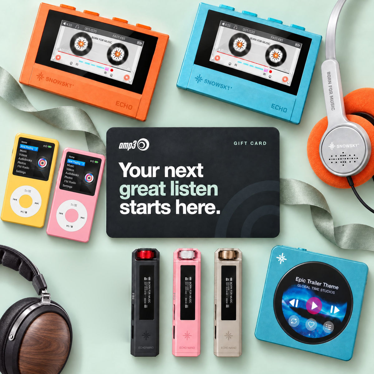 An amp3 gift card surrounded by colourful music players (Snowsky ECHO, INNIOASIS Y1, Snowsky Echo Nano and Disc), orange Snowsky Wind headphones and FiiO FT1 walnut headphones