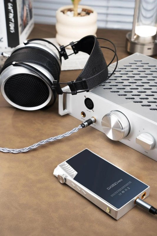 iBasso Kunlun GaN desktop headphone amp, on a desk with headphones and player