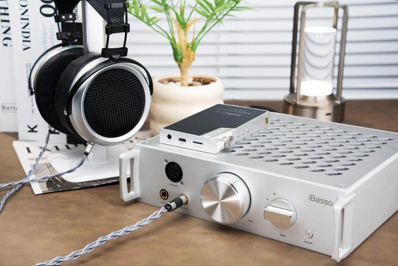 iBasso Kunlun GaN desktop headphone amp, on a desk with headphones