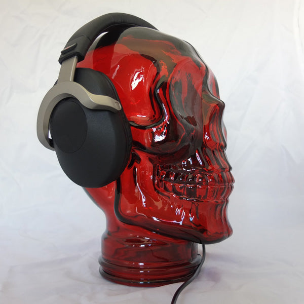 AMP3 glass skull headphone stand, red, with headphones