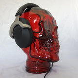 AMP3 glass skull headphone stand, red, with headphones