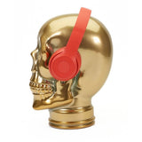 AMP3 glass skull headphone stand, gold, with headphones