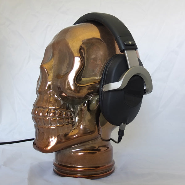 AMP3 glass skull headphone stand, copper, with headphones