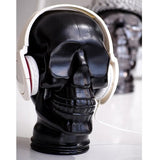 AMP3 glass skull headphone stand, black, with headphones