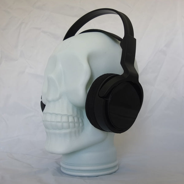 AMP3 glass skull headphone stand, white, with headphones