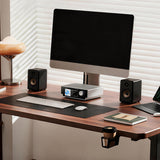 Shanling SM50 in silver on a desk between two bookshelf speakers